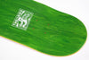 Close-up image of a Green stained skateboard deck with the Theories Brand Enigma logo on a white background