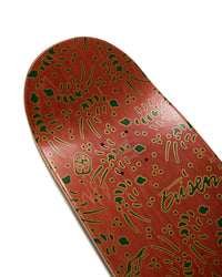 Skateboard deck with red and green pattern on a white background