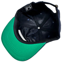 Black and green cap with a visible brand logo on a light background