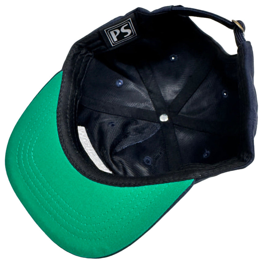 Black and green cap with a visible brand logo on a light background
